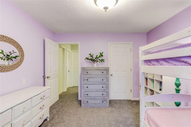 carpeted bedroom featuring a textured ceiling