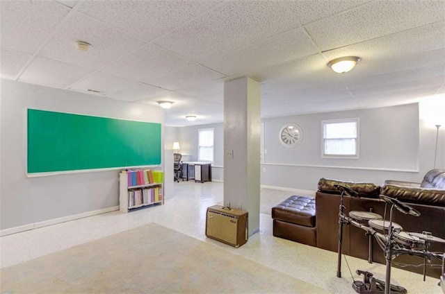 living room with a paneled ceiling and plenty of natural light