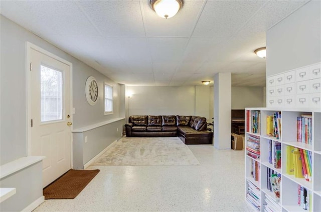 living room featuring a drop ceiling