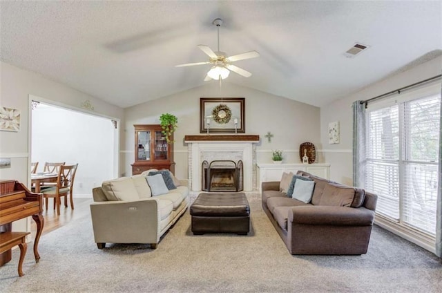 living room with vaulted ceiling, light carpet, and ceiling fan