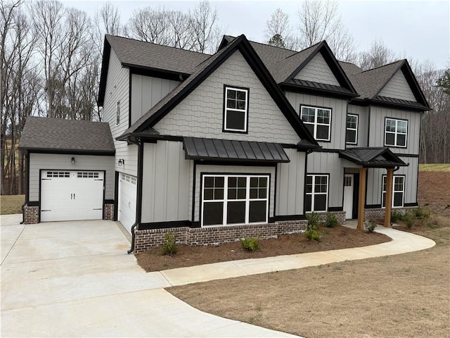 view of front of property with board and batten siding, driveway, and a standing seam roof