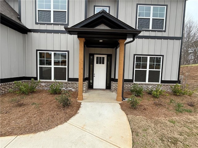 entrance to property featuring brick siding and board and batten siding