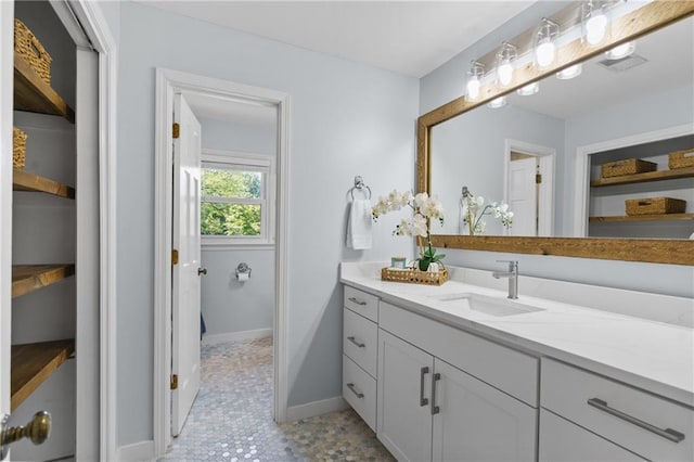 bathroom with vanity and baseboards
