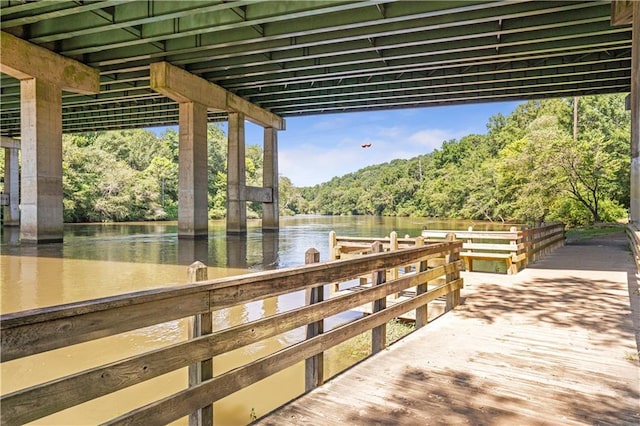 dock area featuring a water view and a forest view
