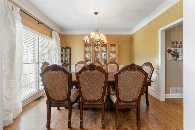 dining area featuring visible vents, plenty of natural light, and an inviting chandelier