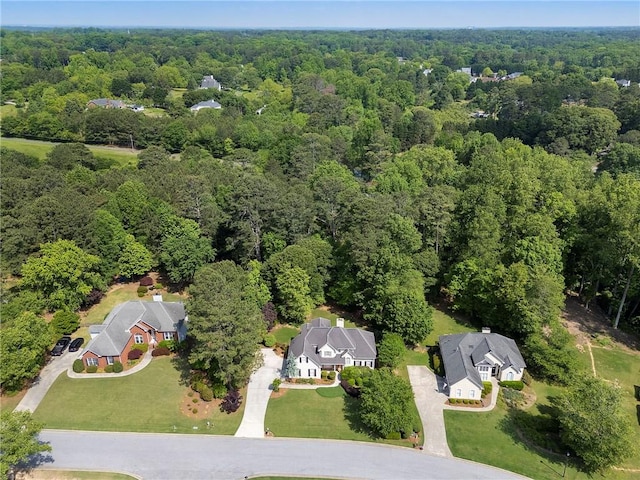 birds eye view of property featuring a wooded view