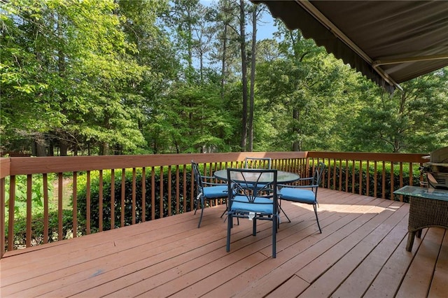 wooden deck with outdoor dining area