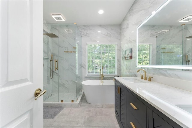 bathroom featuring double vanity, a freestanding tub, recessed lighting, a sink, and a marble finish shower