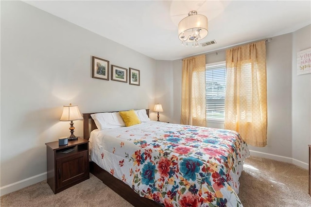 carpeted bedroom featuring baseboards and visible vents