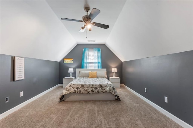 carpeted bedroom featuring a ceiling fan, baseboards, vaulted ceiling, and visible vents