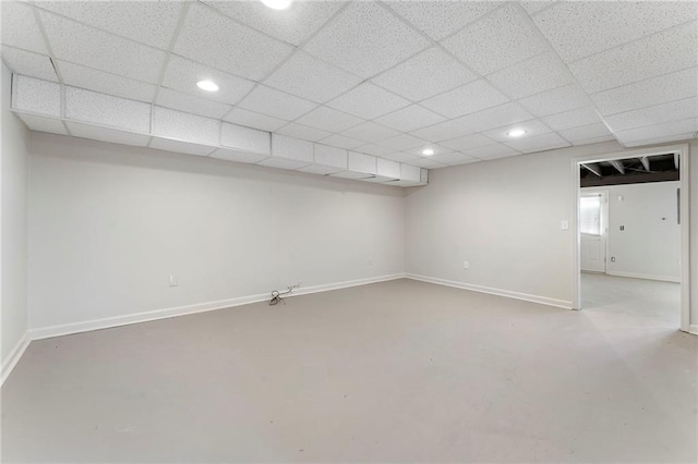 below grade area featuring recessed lighting, baseboards, and a drop ceiling
