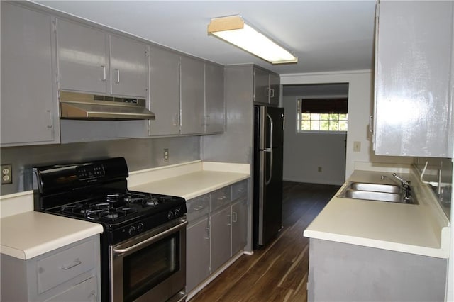 2054 E Roxboro Rd NE, Atlanta, GA 30324 - kitchen featuring stainless steel gas range, under cabinet range hood, a sink, gray cabinets, and freestanding refrigerator
