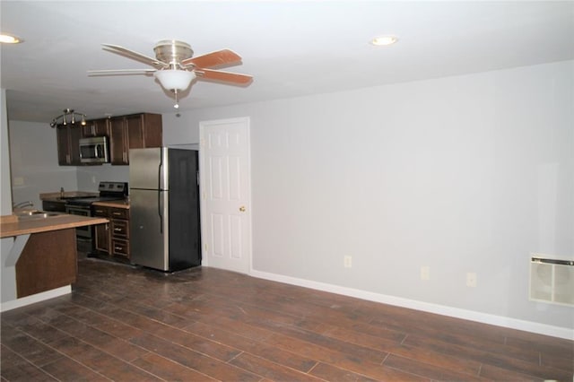 2054 E Roxboro Rd NE, Atlanta, GA 30324 - kitchen with ceiling fan, dark brown cabinets, appliances with stainless steel finishes, a sink, and dark wood-style floors