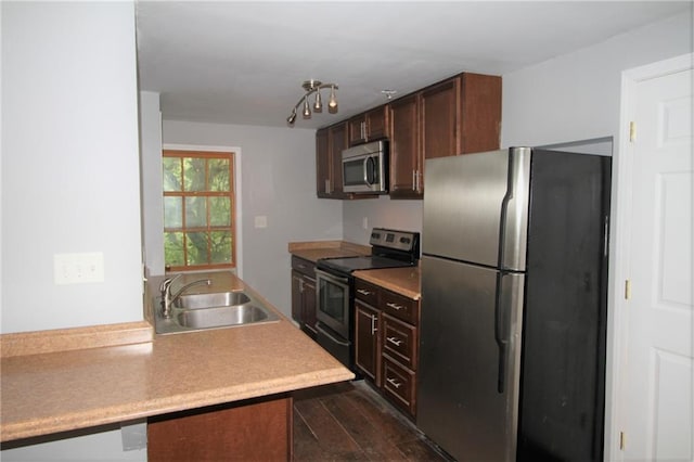 2054 E Roxboro Rd NE, Atlanta, GA 30324 - kitchen featuring light countertops, a sink, appliances with stainless steel finishes, dark wood finished floors, and dark brown cabinets