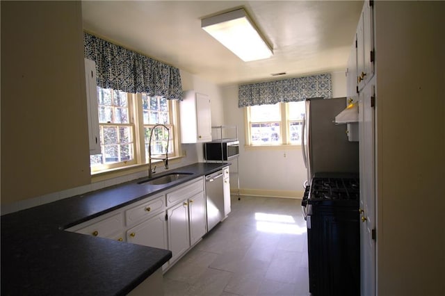 2054 E Roxboro Rd NE, Atlanta, GA 30324 - kitchen featuring stainless steel appliances, a sink, dark countertops, extractor fan, and white cabinets