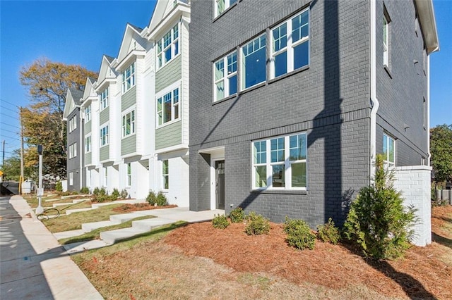 exterior space with a residential view and brick siding