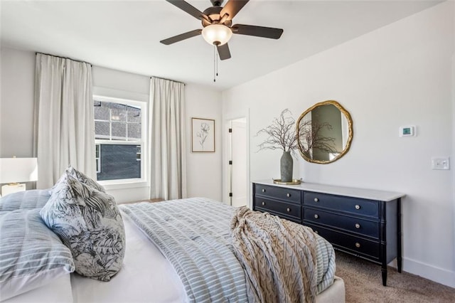 bedroom with ceiling fan, baseboards, and carpet floors