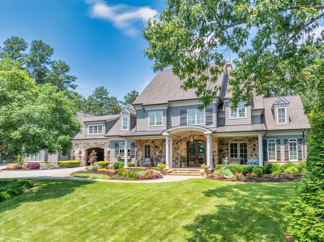 view of front of house with covered porch and a front yard