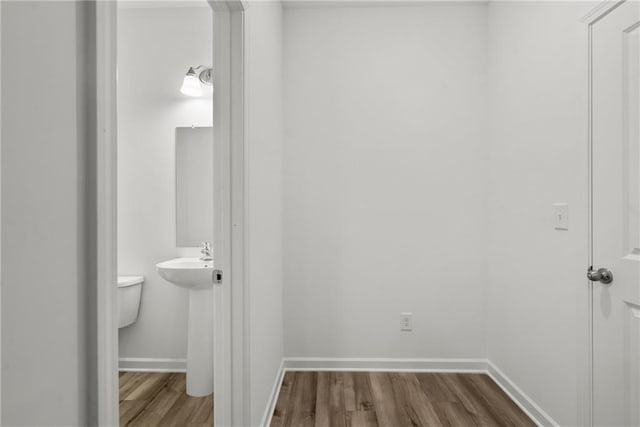 bathroom featuring sink, toilet, and hardwood / wood-style floors