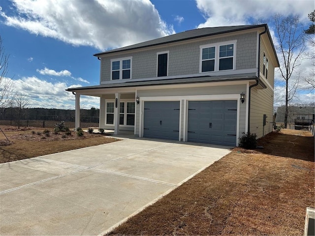 view of property featuring a garage and a porch