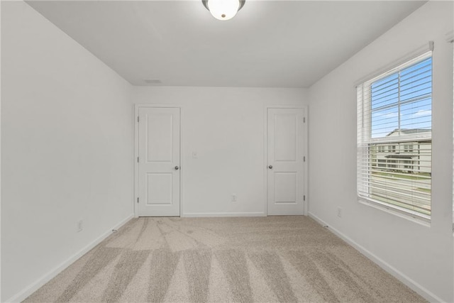 unfurnished room with light carpet