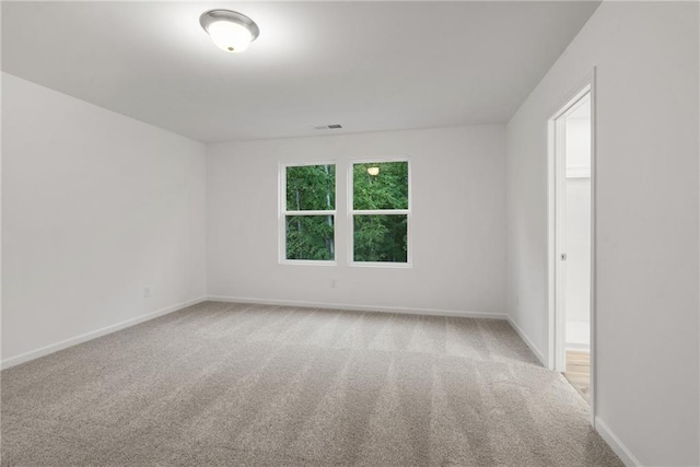 spare room with light carpet