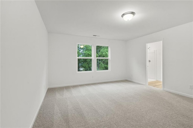 spare room with light colored carpet