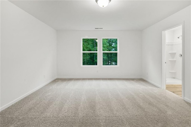 empty room featuring light carpet