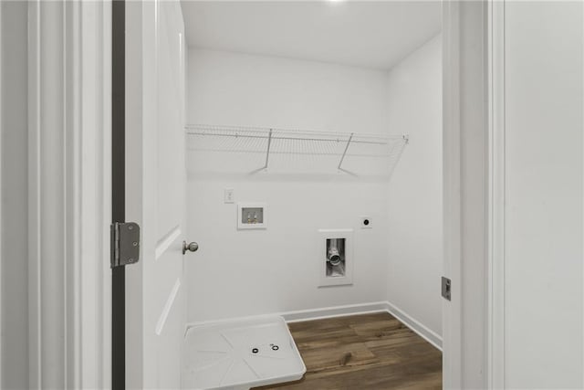 washroom featuring dark hardwood / wood-style flooring, washer hookup, and hookup for an electric dryer