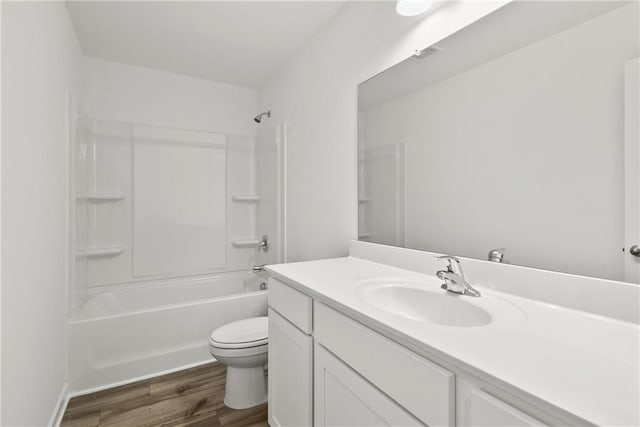 full bathroom featuring wood-type flooring, toilet, vanity, and  shower combination