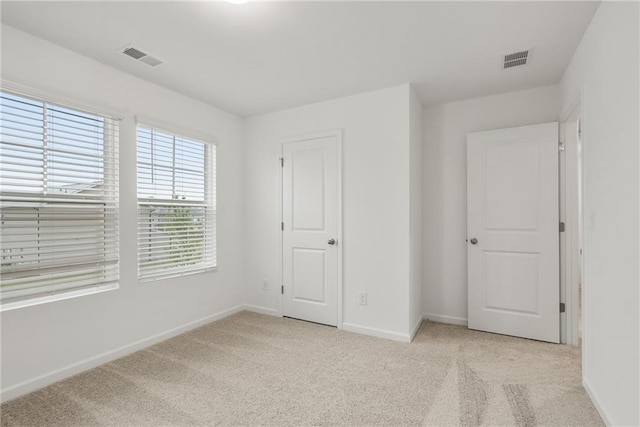 unfurnished bedroom with light carpet