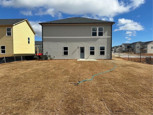 rear view of property with a lawn and a patio area