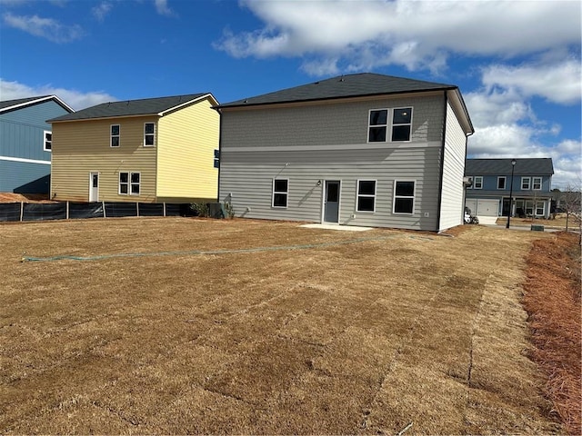 back of property with a patio area and a lawn