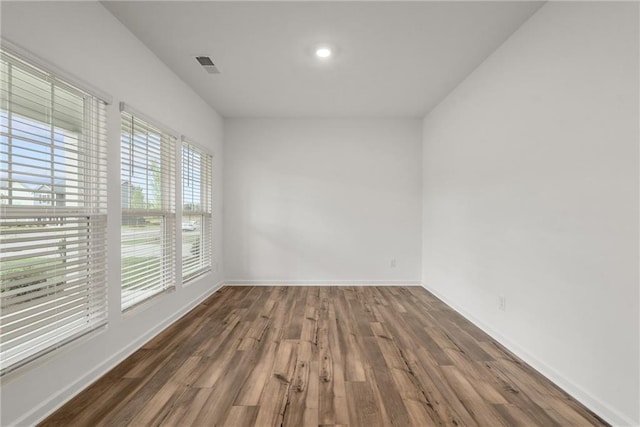 unfurnished room with dark hardwood / wood-style floors