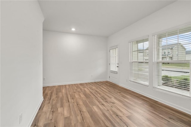 unfurnished room with light wood-type flooring