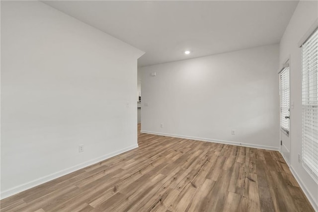 spare room with light hardwood / wood-style floors