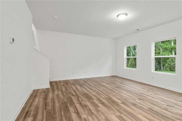 spare room with light hardwood / wood-style flooring