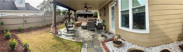 view of patio / terrace featuring fence and ceiling fan