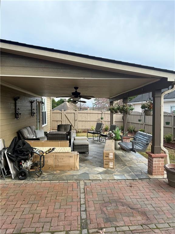 view of patio / terrace featuring a ceiling fan, fence, and an outdoor hangout area