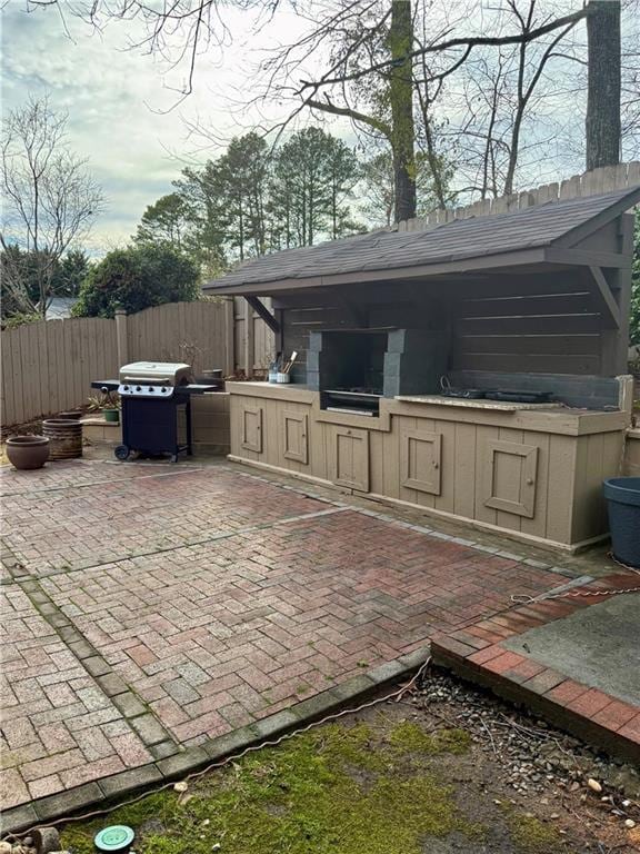 view of patio / terrace with grilling area, exterior kitchen, and fence