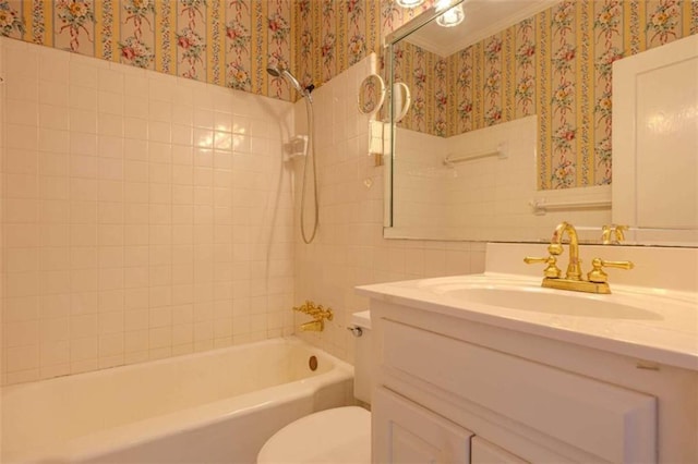 full bathroom featuring tiled shower / bath combo, vanity, and toilet