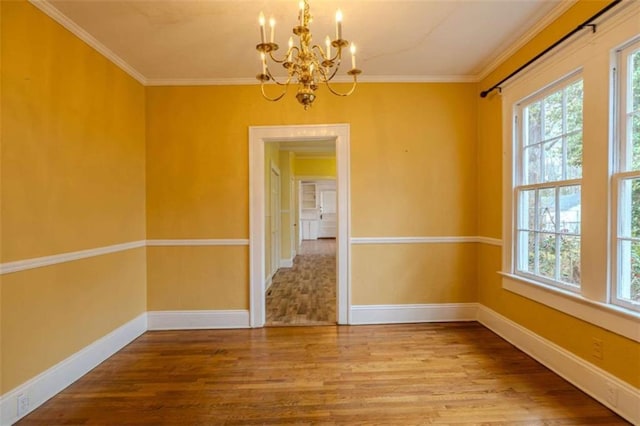 unfurnished dining area with hardwood / wood-style floors, an inviting chandelier, and crown molding