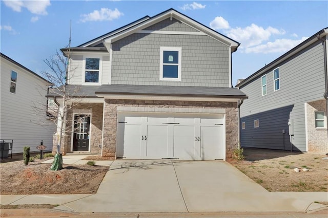 view of front of property with a garage, stone siding, and concrete driveway