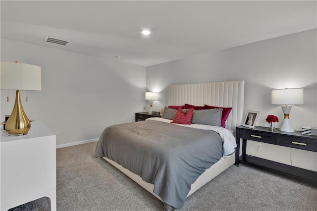 bedroom with light colored carpet, visible vents, baseboards, and recessed lighting