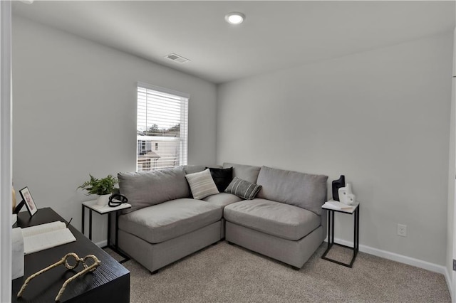 living room featuring light carpet, baseboards, and visible vents