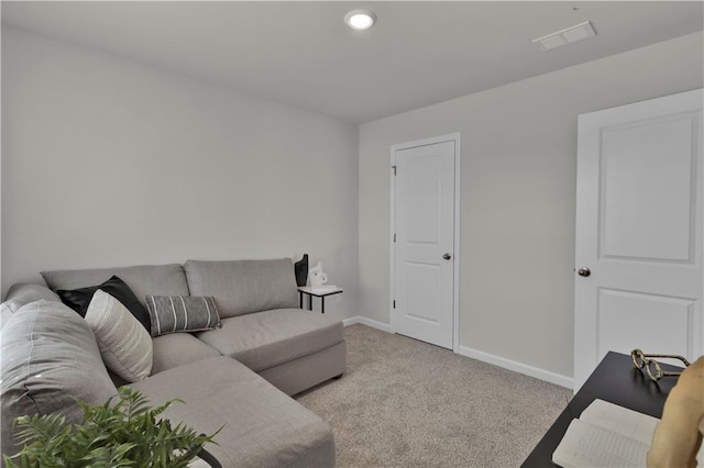 living room featuring baseboards, visible vents, and light colored carpet