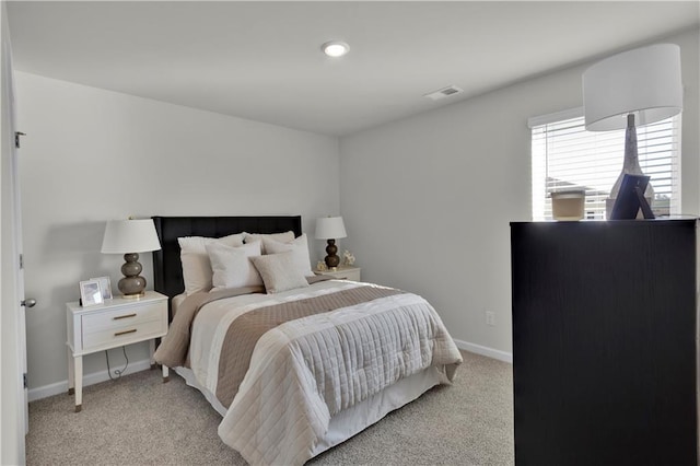 bedroom featuring light colored carpet, visible vents, and baseboards