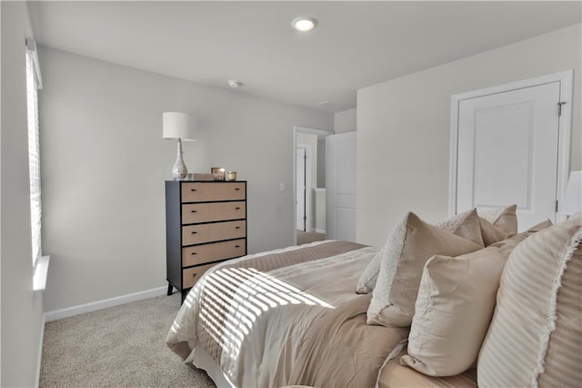 carpeted bedroom featuring baseboards