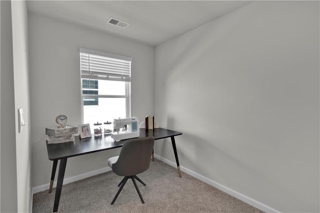 office area featuring carpet flooring, visible vents, and baseboards