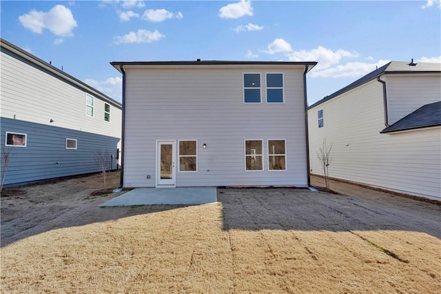 rear view of property featuring a lawn and a patio